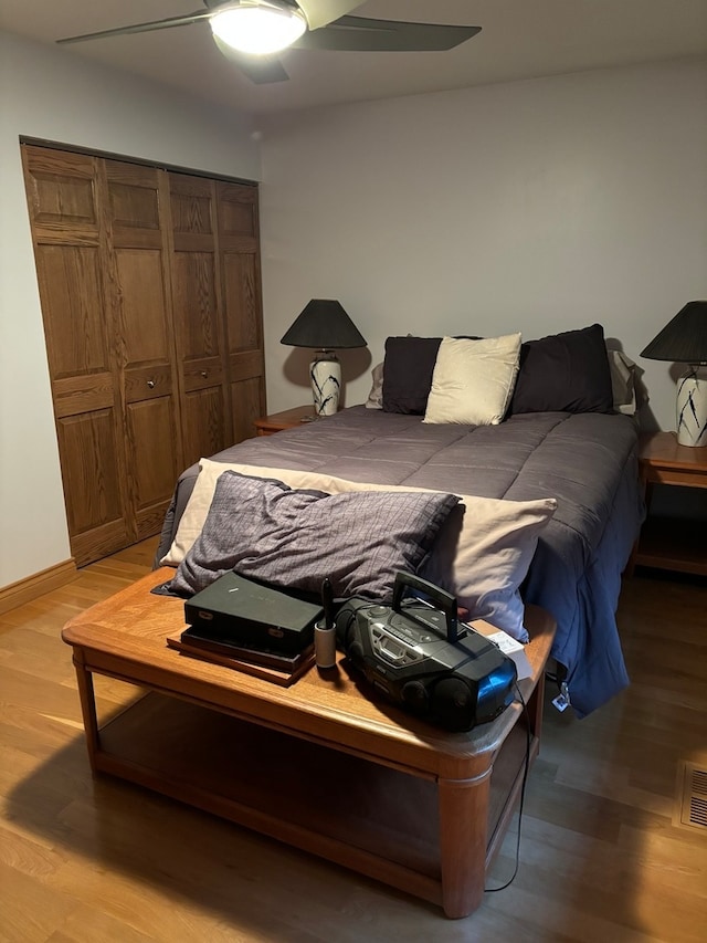 bedroom featuring a closet, light wood-type flooring, and ceiling fan