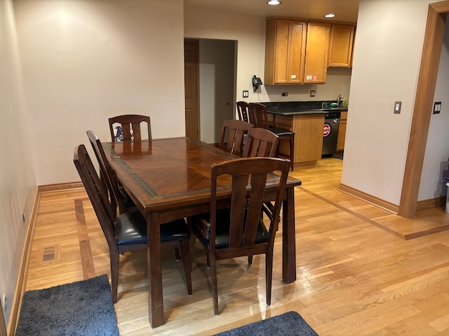 dining space with light hardwood / wood-style flooring