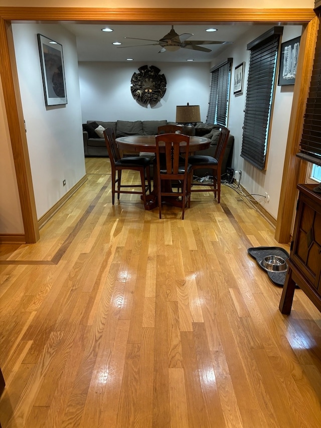 dining area featuring light wood-type flooring and ceiling fan