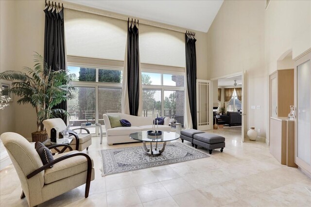 living room featuring tile patterned flooring and a towering ceiling