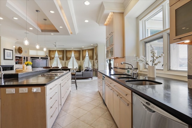 kitchen featuring light tile patterned floors, ceiling fan, stainless steel appliances, pendant lighting, and sink