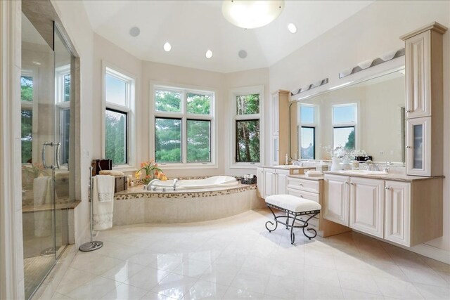 bathroom with tile patterned flooring, shower with separate bathtub, and vanity