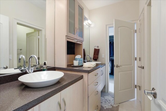 bathroom with tile patterned floors and vanity