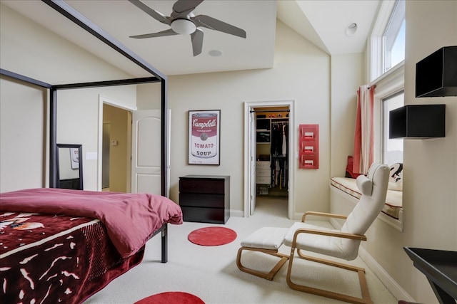 carpeted bedroom with a closet, ceiling fan, and a walk in closet