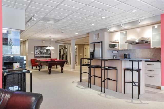 game room featuring rail lighting, light carpet, a paneled ceiling, and pool table