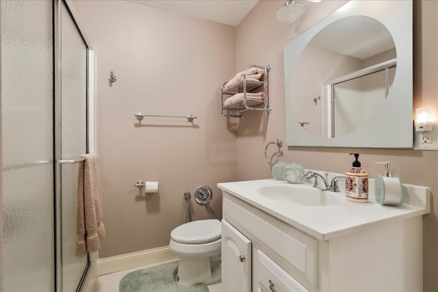 bathroom with vanity, tile patterned flooring, and toilet