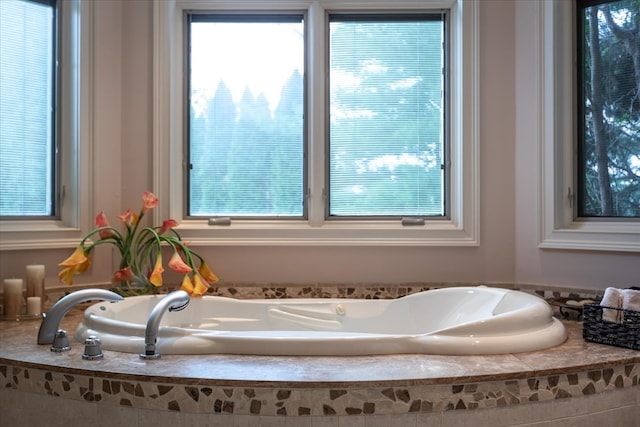 bathroom with tiled bath and a wealth of natural light