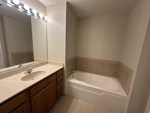 bathroom featuring tile patterned flooring, a bathing tub, and vanity