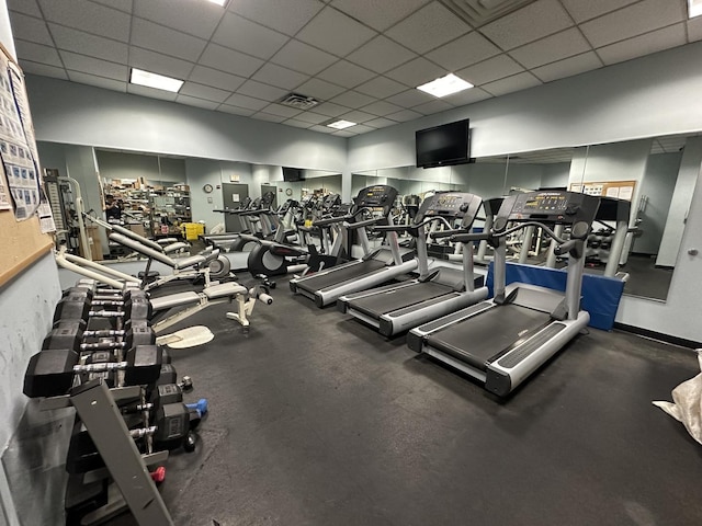 workout area with a paneled ceiling