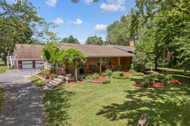 view of front of home featuring a garage and a front lawn