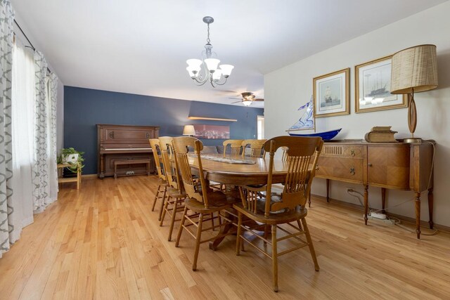 dining room with light wood-type flooring and ceiling fan with notable chandelier