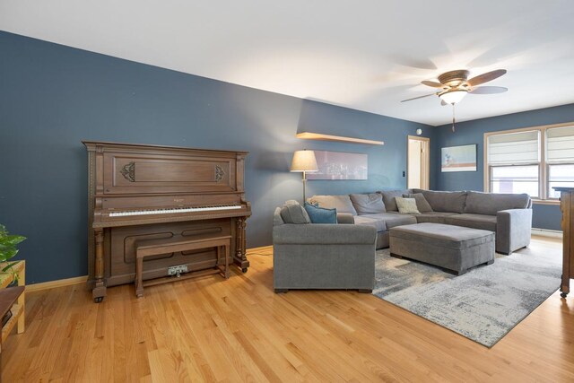 living room with light wood-type flooring and ceiling fan