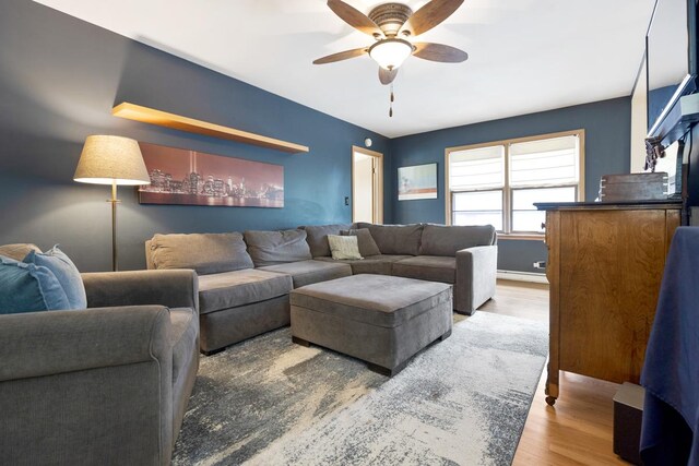 living room featuring wood-type flooring and ceiling fan