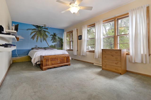 bedroom featuring a baseboard heating unit, carpet flooring, and ceiling fan