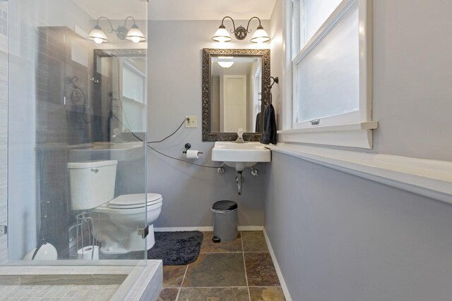 bathroom with a shower, sink, tile patterned flooring, and toilet