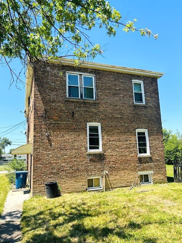 view of side of property with a yard