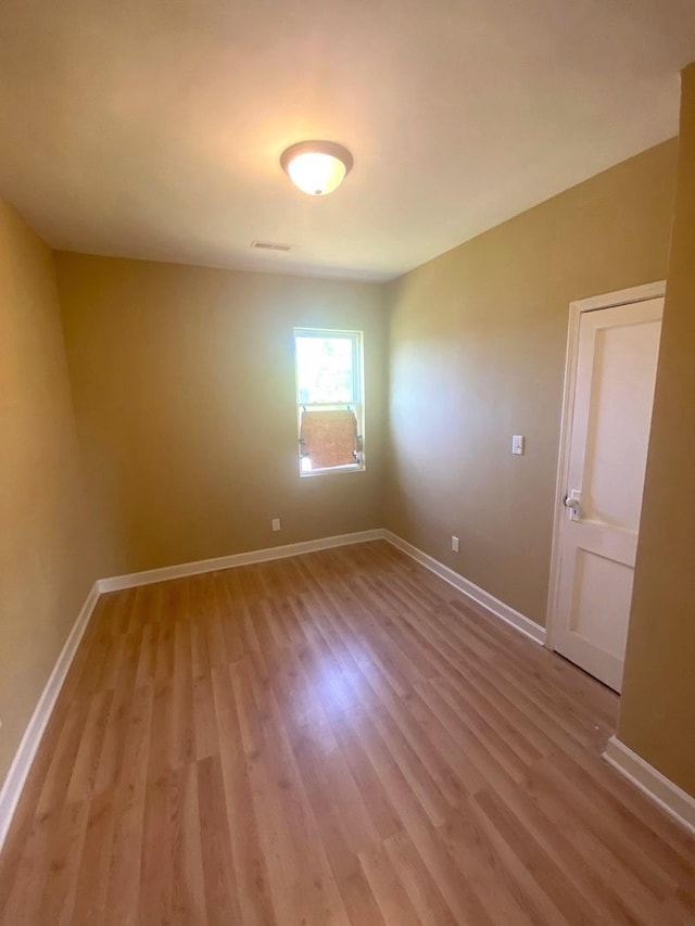 spare room with light hardwood / wood-style flooring
