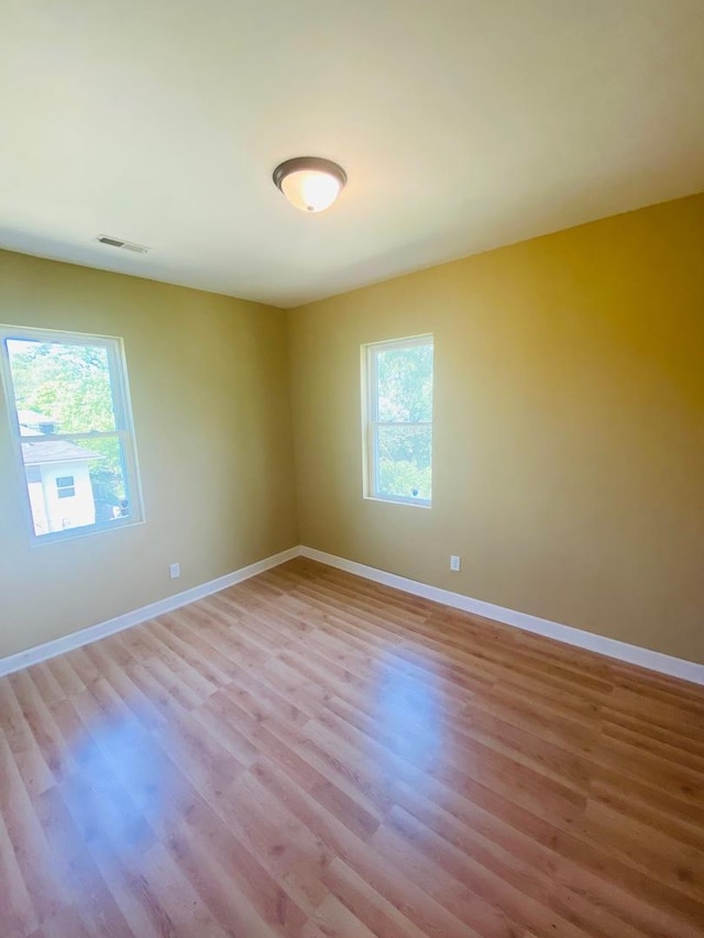 spare room featuring light wood-type flooring