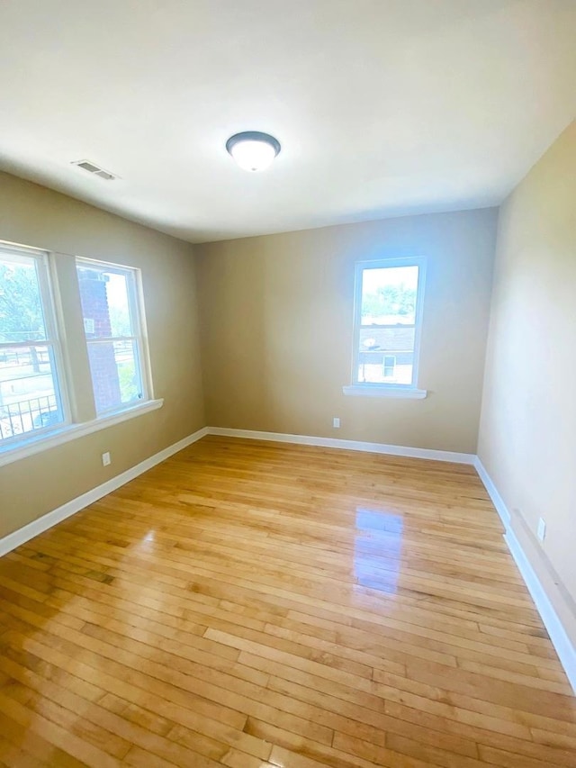 empty room with light hardwood / wood-style floors