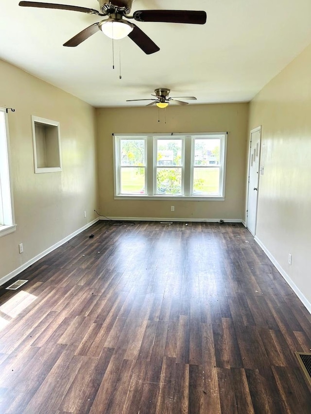 spare room featuring dark wood-type flooring
