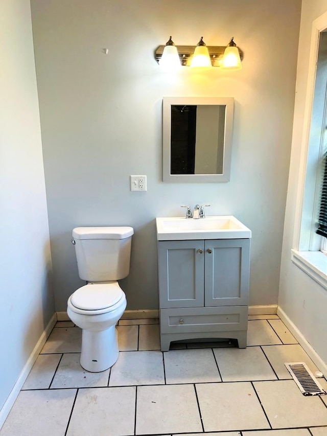 bathroom with tile patterned flooring, vanity, and toilet