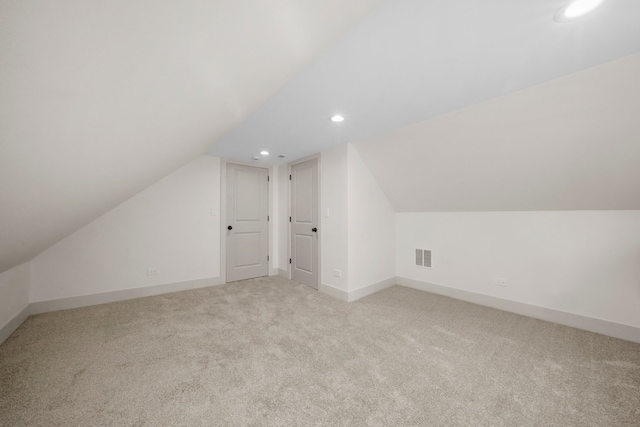 additional living space with lofted ceiling and light colored carpet