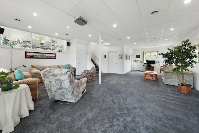 carpeted living room featuring a paneled ceiling