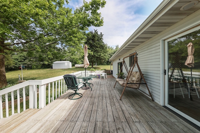 deck featuring a yard and a storage shed