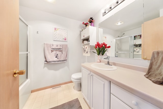 full bathroom featuring tile patterned floors, toilet, vanity, and combined bath / shower with glass door