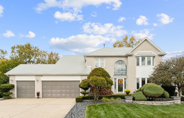 view of front of property with a front lawn and a garage