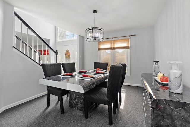 carpeted dining area with an inviting chandelier