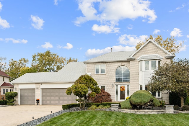 front facade with a front yard and a garage