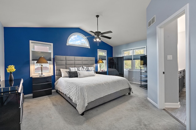 carpeted bedroom featuring high vaulted ceiling and ceiling fan