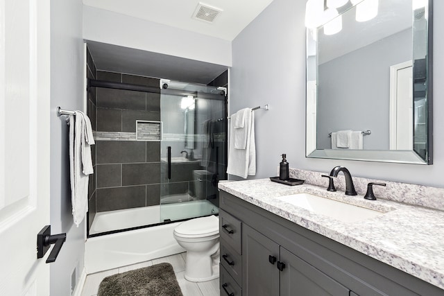 full bathroom with toilet, combined bath / shower with glass door, vanity, and tile patterned floors