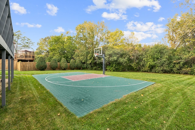 view of sport court featuring a lawn