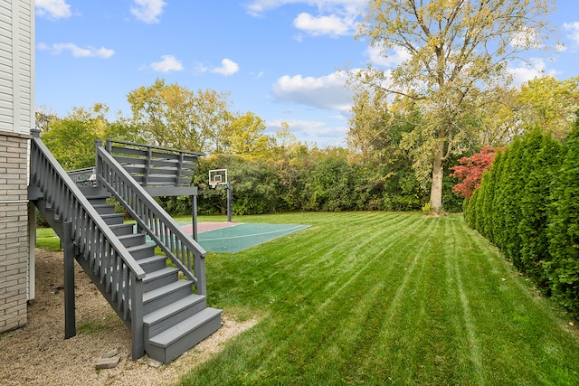 view of yard with basketball hoop