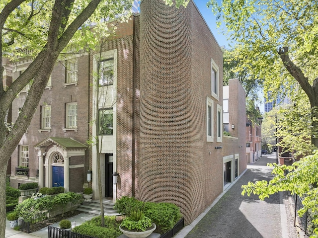 view of side of home featuring brick siding