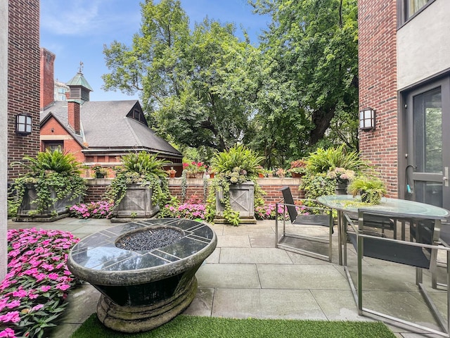 view of patio / terrace with outdoor dining area and an outdoor fire pit