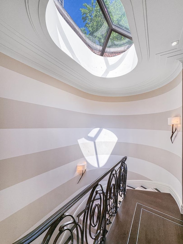 stairway featuring a skylight and carpet floors