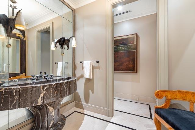 bathroom featuring crown molding and baseboards