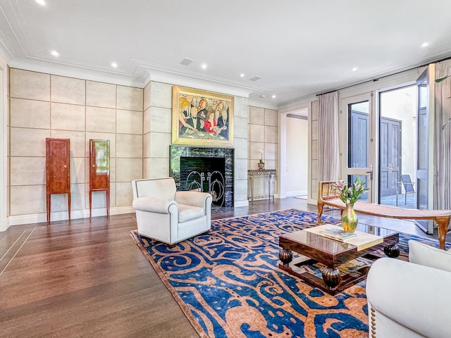 living room with recessed lighting, a high end fireplace, wood finished floors, and crown molding