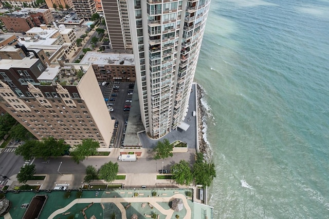 birds eye view of property featuring a view of city and a water view