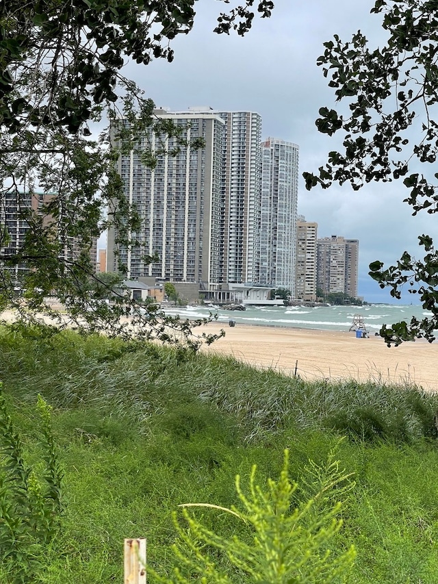 view of building exterior featuring a water view and a city view