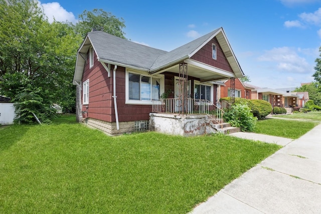 bungalow-style home featuring covered porch and a front yard