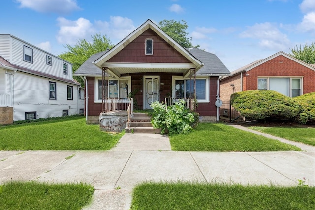 bungalow-style house featuring a porch and a front lawn