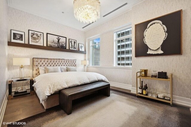 bedroom with ornamental molding, dark hardwood / wood-style flooring, an AC wall unit, and a chandelier