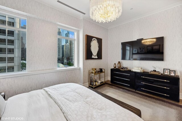 bedroom with crown molding, carpet flooring, and a notable chandelier