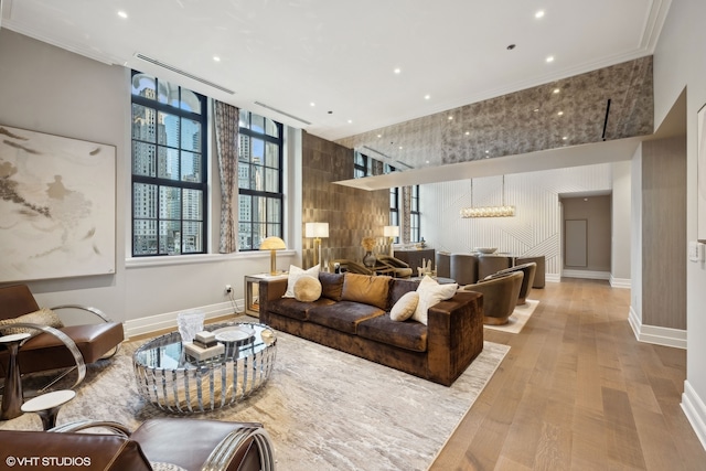 living room featuring light hardwood / wood-style flooring and ornamental molding