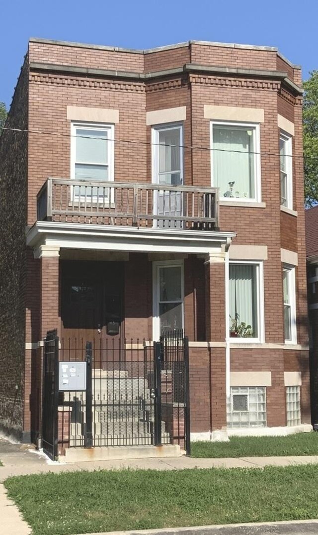 6639 S Rhodes Ave, Chicago, IL 60637 - view of front of house with a balcony and brick siding