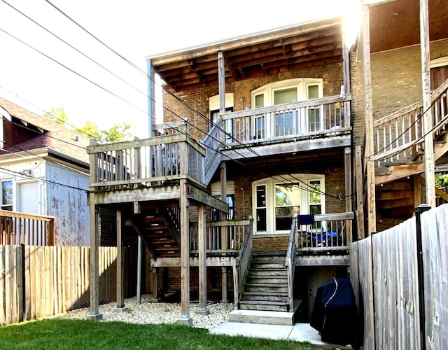 6639 S Rhodes Ave, Chicago, IL 60637 - back of house featuring stairs, brick siding, and a balcony